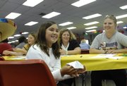 Madison Hart, 9, of the Eudora 4-H Club plays a fortune pyramid with her mother, Shari Hart, not pictured, as Kelly Neis, far right, and Kim Gabriel watch.