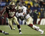 Florida State's Antone Smith (6) runs past Boston College's Tyronne Pruitt (48). The Seminoles toppled No. 2 BC, 27-17, on Saturday in Boston.