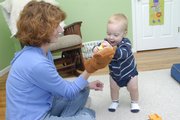 Sandy Beverly and her 1-year-old son Max play in Max's room on Thursday. Beverly says she decided to try cloth diapers because she thought it was better for the environment and cheaper than using disposable diapers.