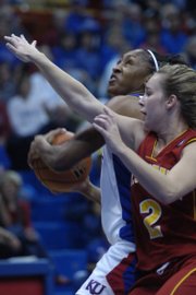 Kansas University forward Taylor McIntosh, left, drives past Pitt State senior guard Liz Witte. The Jayhawks opened their exhibition season with an 82-48 victory over the Gorillas on Sunday in Allen Fieldhouse.