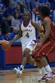 Danielle McCray dribbles downcourt during the Jayhawks' 82-48 exhibition victory over Pittsburg State. McCray led the Jayhawks with 20 points Sunday in Allen Fieldhouse.