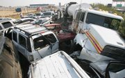 More than 100 vehicles were involved in a series of collisions Saturday on Highway 99 south of Fresno, Calif. At least two people were killed and dozens more were injured in a massive pileup on the foggy freeway, the California Highway Patrol said.