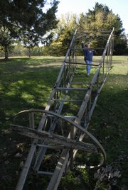 Martha Parker, executive director of the River Valley Heritage Museum, approaches a windmill that was moved Saturday to Clinton Lake's Bloomington Park. The windmill will be fitted with a light beacon as a symbol of the area's Civil War and Underground Railroad heritage.