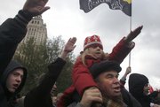 Ultranationalist demonstrators give fascist salutes during a rally in downtown Moscow. Demonstrators complained of the presence in Russia of dark-skinned migrants from other former Soviet republics. The political and economic turmoil that followed the collapse of the Soviet Union generated hostility toward foreigners, especially the millions of migrant workers in Russia.