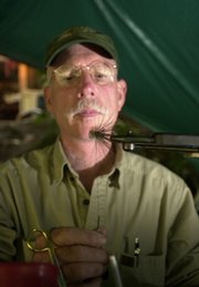 Lee Spencer ties a fly. Spencer has been cutting the points off his hooks since becoming the FishWatch guardian of a pool filled with steelhead.