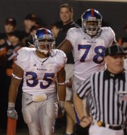 Kansas running back Brandon McAnderson celebrates in the end zone with offensive lineman Anthony Collins, back, following McAnderson's touchdown during the first half Saturday, Nov. 10, 2007 at Boone Pickens Stadium in Stillwater.