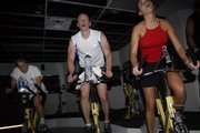 From left, Marsha Wilson, of Merriam, Christian Nafziger, of Westwood Hills, and Kristen Matthews, of Kansas City, Mo., pedal through a high-resistance phase of the workout.
