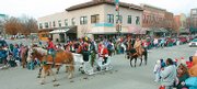 Parade participants greet spectators as they make their way down Massachusetts Street during the 2006 Lawrence Old-Fashioned Christmas Parade. This will be the 15th year for the event.