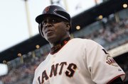 Former San Francisco slugger Barry Bonds waits for his turn to bat in this file photo from Aug. 7. Bonds was indicted Thursday for perjury and obstruction of justice.