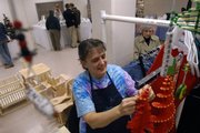 Suzanne Griffin, Topeka, attaches beads to a wind spinner Sunday, Nov. 18, 2007 in her booth at the Holiday Bazaar at the Community Building, 115 W. 11th St. She has been coming to the bazaar for three years.