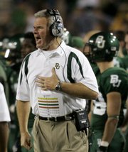 Guy Morriss shouts instructions to players in the first half of Baylor's 45-14 loss to Oklahoma State on Saturday in Waco, Texas. On Sunday, Morriss was fired as the Bears' coach.