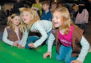 Kykee Wiggins, left, Brooke Stillian and Ryan Elvridge wait their turn at Basket Bounce, part of the 2006 Bromelsick Christmas Party for Scouts and 4-H participants. This year's event will be Dec. 2 at the Douglas County 4-H Fairgrounds Community Building.