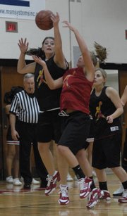 Lawrence High basketball player Shelby Miller, left, rebounds the ball against Taylor Bird. Lawrence&squot;s varsity and junior varsity girls teams scrimmaged at "Pack the House" on Monday at LHS.