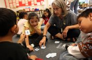 Montgomery County, Md., elementary school teacher Sheila Etzkorn works with Immanuel Sagastume, left, Sandy Alvarenga and Tony Lizama in a class for gifted students. Nancy Green, director of the National Association for Gifted Children, criticized the No Child Left Behind law: "Because it's all about bringing people up to that minimum level of performance, we've ignored those high-ability learners."