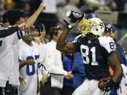 Dallas receiver Terrell Owens throws popcorn in his face after scoring a second-quarter touchdown. The Cowboys defeated Green Bay, 37-27, on Thursday night in Irving, Texas.