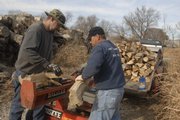Don Cottrell, left, and Darryl James split firewood in North Lawrence. Cottrell said he has about 225
customers in the area who regularly buy wood by the cord - a pile that measures 8 feet long, 4 feet wide and 4 feet high.