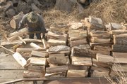 Don Cottrell stacks seasoned hardwood. The type of wood and its age can affect safety, woodcutters say.