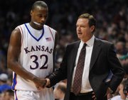 Darnell Jackson, left, and Bill Self shake hands after a victory against Eastern Washington. About a year ago, Jackson told Self he was thinking about moving home to be with his family. "The hand that&squot;s been dealt to that family ... you&squot;d say no family can endure that much," Self said.