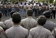 Activists paint their bodies for campaign against climate change during a demonstration as Indonesian police block a road to keep them from proceeding to the U.N climate conference venue on Friday in Nusa Dua, Bali, Indonesia. Delegates from nearly 190 nations are attending the Dec. 3-14 gathering in Bali, which is charged with launching negotiations that will eventually lead to an international accord to succeed the 1997 Kyoto Protocol on global warming.
