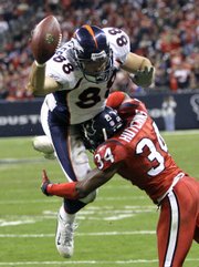 Denver Broncos tight end Tony Scheffler (88) leaps for the end zone as Houston Texans defensive back Von Hutchins (34) defends. The Texans beat the Broncos, 31-13, Thursday in Houston.