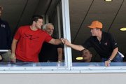 AP Player of the year Tim Tebow, left, shakes hands with a fan at Sunday's Tampa Bay Buccaneers game. Tebow, who also won the Heisman Trophy, was honored by the AP on Tuesday.