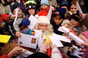 A Santa Claus impersonator is surrounded by children at the Christmas Post Office in Himmelpfort, which means "Heavens Gate," in northern Germany. Germany&squot;s postal service runs two special post offices to handle and answer children&squot;s wish lists to Santa.