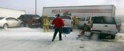 Amarillo firefighters aid victims still in their vehicles after a major pileup Saturday on I-40 near Pullman Road in Amarillo, Texas. About 80 vehicles were involved in the massive pileup that resulted in at least one fatality and shutdown Interstate 40 and Highway 287 for much of the day.