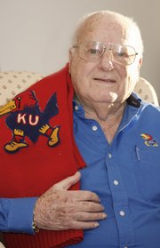 Dick Wintermote was a Kansas University cheerleader during the 1948 Orange Bowl. He displayed his cheerleading sweater Tuesday at his west Lawrence home.