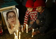 Pakistani children participate in a candle-lit ceremony in memory of slain opposition leader Benazir Bhutto in Lahore, Pakistan. Pakistan's election commission on Tuesday postponed next week's parliamentary voting until February.