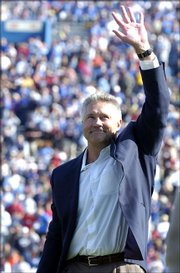 Former Kansas University quarterback Nolan Cromwell salutes the crowd at Memorial Stadium after being inducted into the KU Ring of Honor. Cromwell, receivers coach for the Seattle Seahawks, was named offensive coordinator at Texas A&M on Saturday.