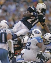 San Diego Chargers' Ladainian Tomlinson goes over the top for a one-yard touchdown in the fourth quarter. The Chargers beat the Tennessee Titans, 17-6, Sunday in San Diego to advance in the AFC playoffs.