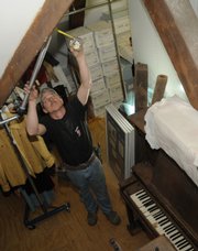 Steve Douglas, foreman with Jayhawk Fire Sprinkler Co. in Topeka, installs water pipe lines Tuesday in the attic of Watkins Community Museum of History, 1047 Mass. The museum is in the process of installing a new sprinkler system inside the museum.