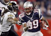 New England running back Laurence Maroney, right, rushes past Jacksonville's Terry Cousin. The Patriots defeated the Jaguars, 31-20, on Saturday night in Foxborough, Mass.