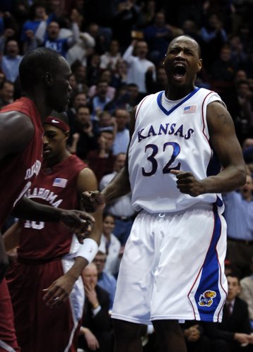 Kansas University forward Darnell Jackson roars after a dunk on the opening drive against Oklahoma. The slam set the tone for Jackson and the Jayhawks; he went on to lead KU with 17 points in an 85-55 blowout of the Sooners on Monday at Allen Fieldhouse. Jackson was officially traded to the Kings Wednesday.