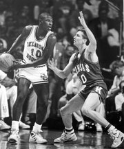 Mookie Blaylock, left, looks to make a pass against Scooter Barry during the Jayhawks' 83-79 win over the Sooners on April 4, 1988, to secure the school's fourth national championship.