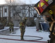 Firefighters from Lawrence-Douglas County Fire & Medical respond to a fire Saturday morning at Heatherwood Valley Apartments, near Clinton Parkway and Kasold Drive. One person suffered nonlife-threatening injuries, and about 20 residents were displaced.