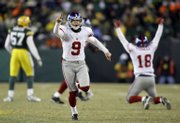 Giants kicker Lawrence Tynes (9) celebrates after kicking the game-winning field goal. Tynes missed twice but connected in overtime Sunday in Green Bay, Wis.