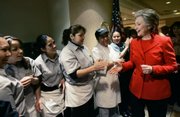 Democratic presidential hopeful Sen. Hillary Rodham Clinton, D-N.Y., greets hotel workers during a campaign stop at the Mandalay Bay Hotel on Saturday in Las Vegas before the Nevada caucuses. Clinton says she understands the economic pressures felt by people across the county, and wants to put forth a plan that helps individuals get their finances in order.