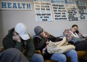 Kevin Lavene, from left, Carol (no last name given) and Tanika Halcrombe sit in the waiting room at Health Care Access. The clinic is the largest operation of its kind serving uninsured Douglas County residents. Health Care Access is starting a serious push to expand or relocate its operations after seeing a record-setting number of patients in 2007.