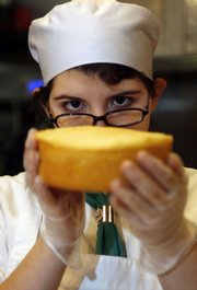 Maria Del Mar Baez, a student at Johnson & Wales University, checks the level of a cake while interning Wednesday at Johassen's Bakery Cafe in Providence, R.I. Johnson & Wales University, which runs the bakery, has started phasing out trans fats in its restaurants, hotels and dining services on campuses in Providence, North Miami, Fla., Denver and Charlotte, N.C., and plans to be trans fat-free by the fall semester.