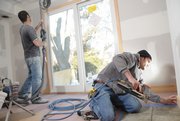 Gria Inc. crew members Brent Wallis, of Lawrence, left, and Michael Camacho, of Kansas City, Mo., sand walls and install wood trim on a remodeling project at 1650 Cambridge Road. A Lawrence company, Gria is staying busy even in a construction downturn by concentrating its design firm, fabrication shop and construction company on a broad range of projects, including custom homes and remodeling.