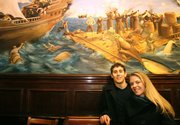 Brian Ascher and his fiance, Erika Gunderson, pose for a photograph Wednesday in New York in Burp Castle, an East Village bar that was a key piece in the puzzle of tracking down the owner of a Canon digital camera Gunderson found in a New York taxi. By matching the photographs in the camera with details in this bar and Standings, the bar next door, the couple tracked down the camera's owner in Sydney, Australia.