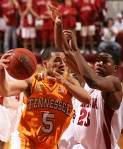 Tennessee's Chris Lofton (5) drives to the basket as Alabama's Demetrius Jemison (23) defends in the first half Tuesday in Tuscaloosa, Ala.
