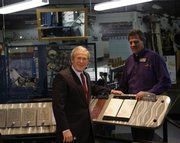 President Bush stops to chat with Hallmark employee Rick Eisel, right, during his tour of Hallmark Cards Inc. Friday in Kansas City, Mo.