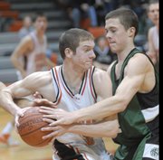 Free State's Weston Wiebe, right, pressures a Shawnee Mission Northwest player. The Cougars edged the Firebirds, 61-56, Tuesday in Shawnee.