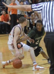 Free State's Kris Wilson, right, goes for a steal against Shawnee Mission Northwest. The Firebirds lost, 61-56, Tuesday in Shawnee.