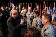 KU Chancellor Robert Hemenway talks with wounded soldiers Wednesday at Fort Leavenworth. A new program will allow wounded soldiers to earn their master's degrees while remaining in the Army.