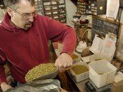 Brewmaster Steve Bradt of Free State Brewing Co., 636 Mass., measures out hops for the next day's brewing.