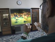 Billy Perry uses a Nintendo Wii Sports Boxing game for therapy at WakeMed Hospital in Raleigh, N.C. The hospital has begun using the Wii games to help patients like Perry, who suffered a stroke, regain strength and endurance.