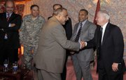 Iraqi Vice President Adil Abd Al-Mahdi, center, and U.S. Secretary of Defense Robert Gates shake hands Sunday during an unannounced visit with Iraqi government officials in this photo provided by the U.S. Department of Defense.